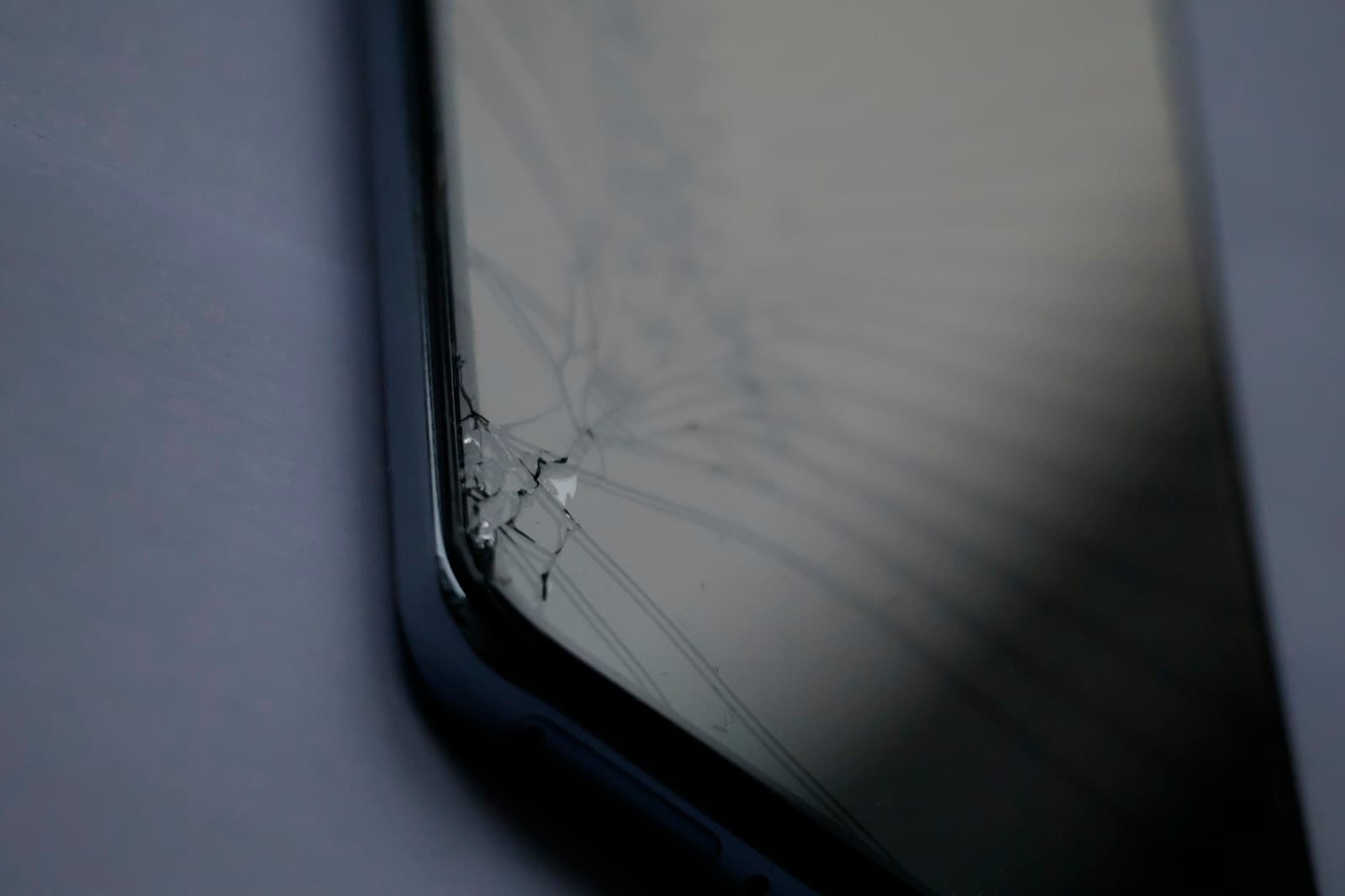 Smartphone with a cracked screen ready for replacement Smartphone with a cracked screen ready for replacement